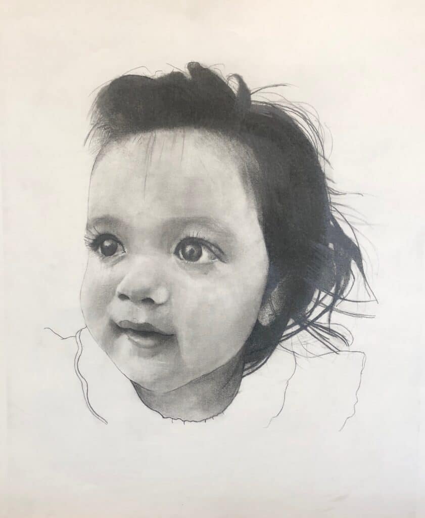 A pencil drawing of a young child with big eyes, tousled dark hair, and a soft expression, wearing a simple top with a scalloped collar. The portrait is detailed while the edges and background are unfinished.
