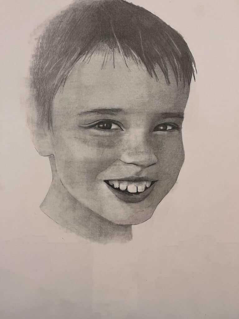 A pencil drawing of a smiling young boy with short hair, visible teeth, and light shading on his face against a plain background.