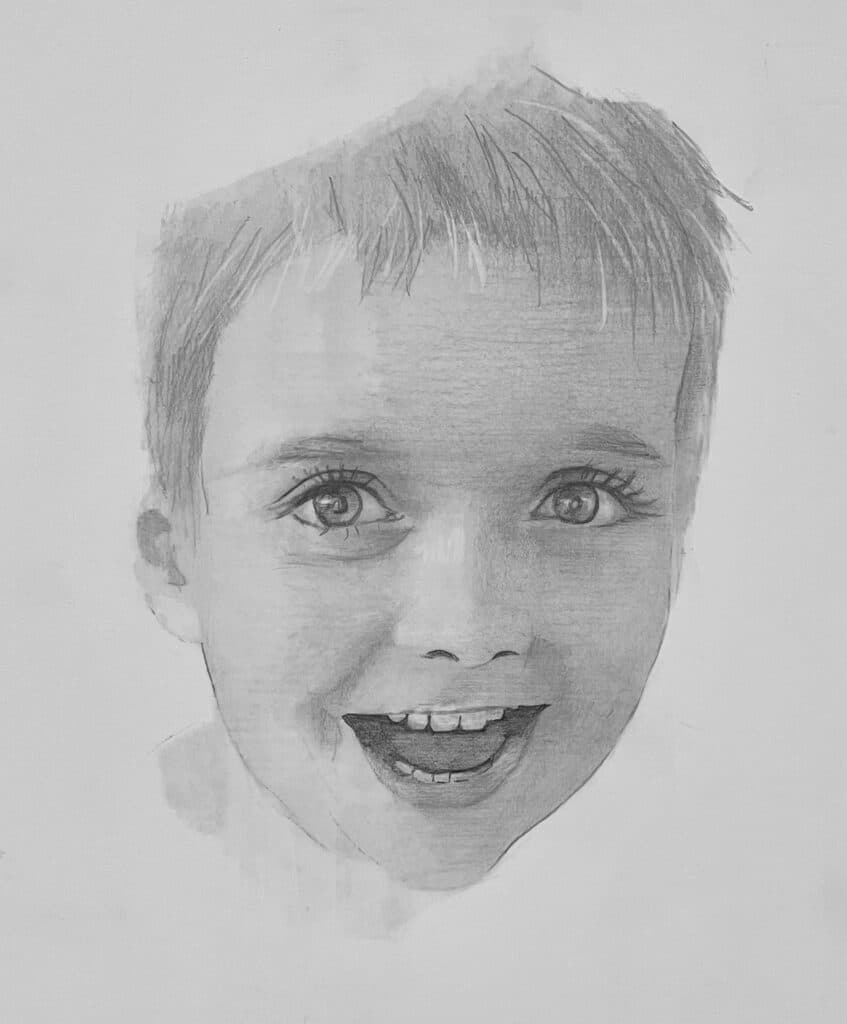 A pencil sketch of a young child’s face, showing wide eyes, a big smile, and short hair. The expression appears happy and surprised. The background is plain and white.
